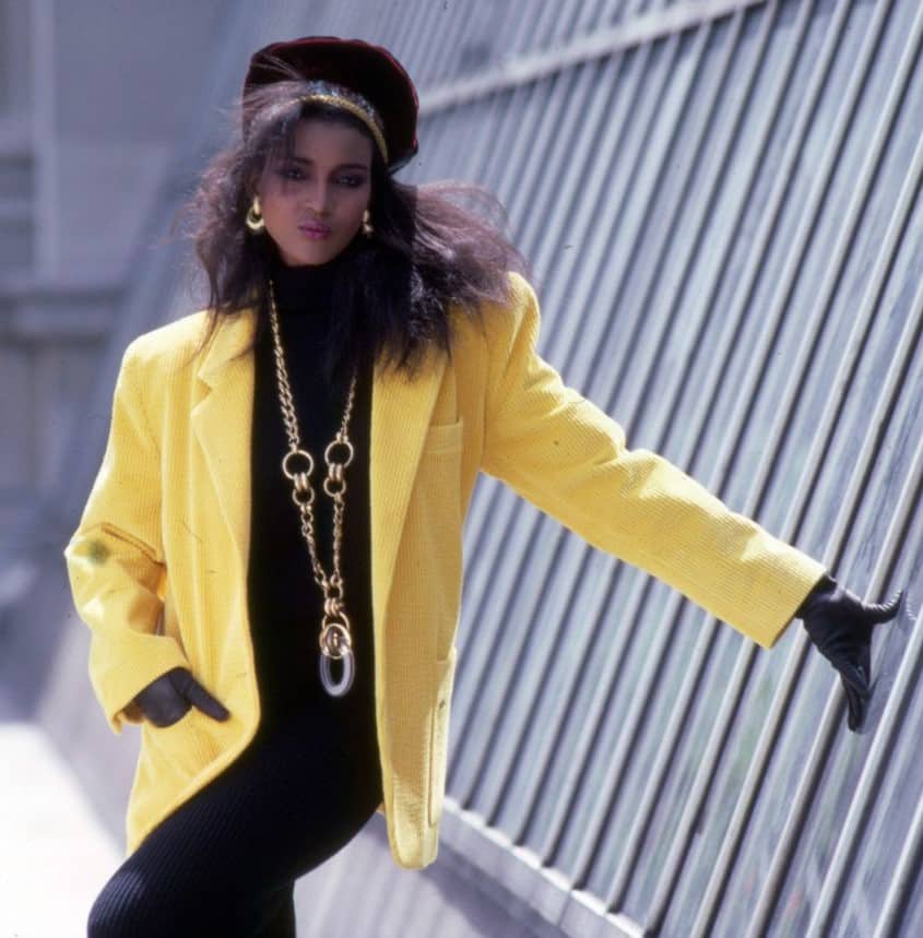 the computer age - young girl with wild hair and chunky jewellery with black clothes and bright yellow jacket