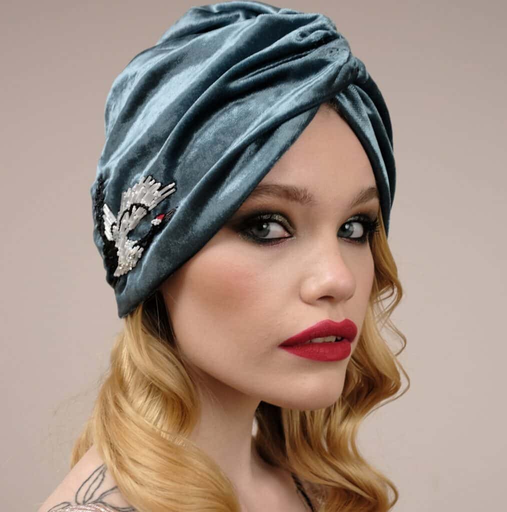 fitted hats - woman wearing a crushed velvet turban with embellisment