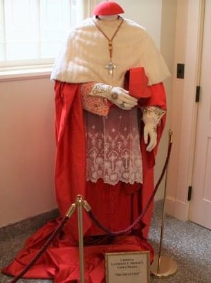 gloves in ancient times - mannequin display of a pontif cassock with full regalia and embroidered gloves