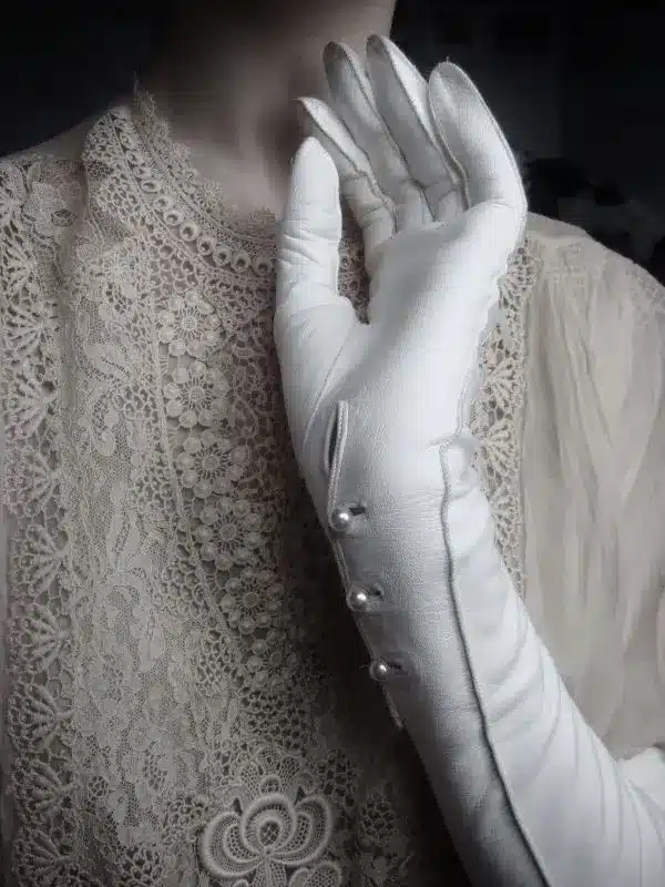 ancient times - edwardian lady holding up a hand wearing white dress gloves 