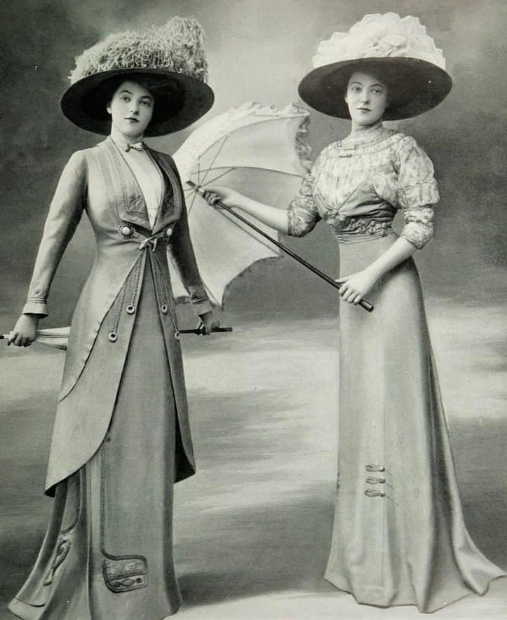 the victorian era - twin girls posing for a photo in walking suits