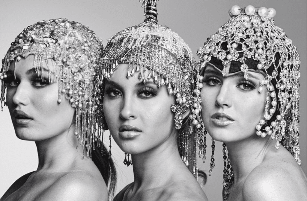 creating a vintage style - 3 women with headshots standing together wearing assorted beaded skull caps