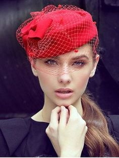 world war 2 - woman in navy dress and red adorned bonnet hat