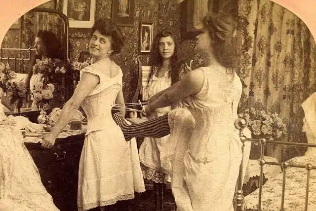 the victorian era - women helping each other to tighten their corsets