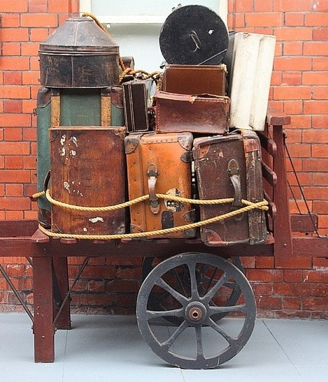 suitcases were invented - an old cart with vintage suitcases piled on top