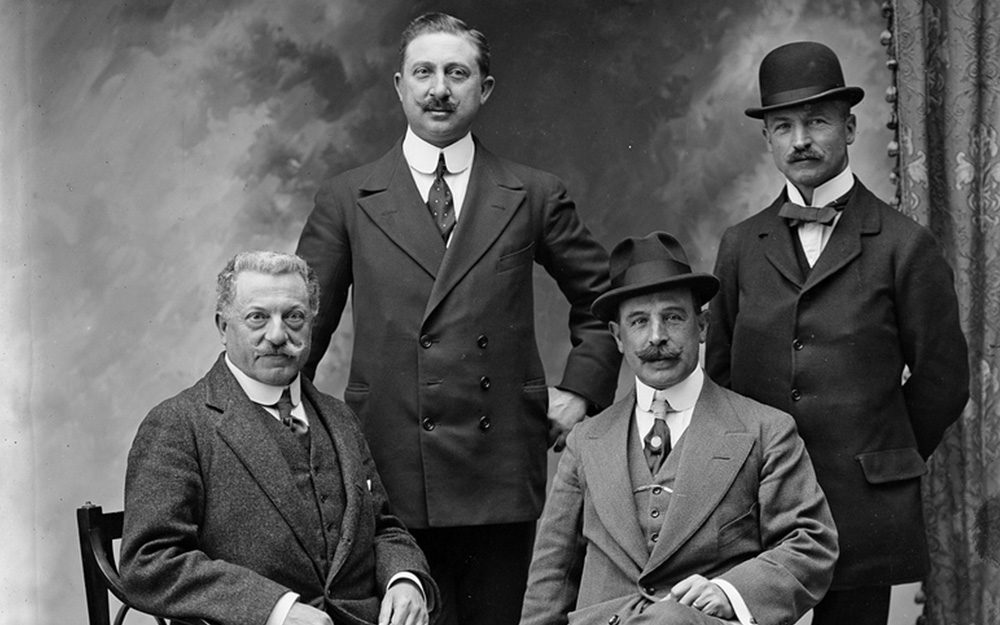 the edwardian gentleman - 4 men in detachable collared suits in a studio setting