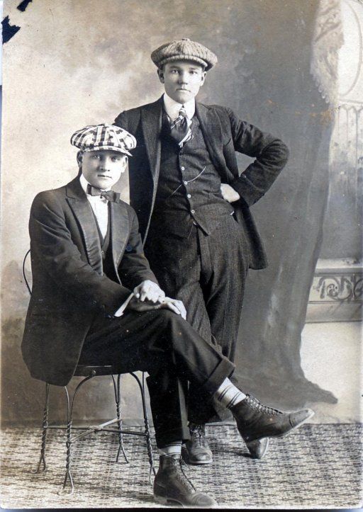 the gangster, roaring 20's two young men in 3 piece suits, boots and newsboy caps