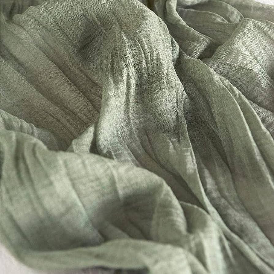 the beauty and appeal of vintage fabrics - piece of cheesecloth or muslin fabric in light khaki green