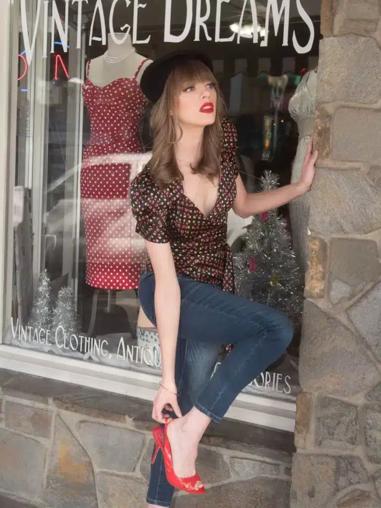 where to get it - young woman outside specialty vintage shop wearing jeans blouse and red heels