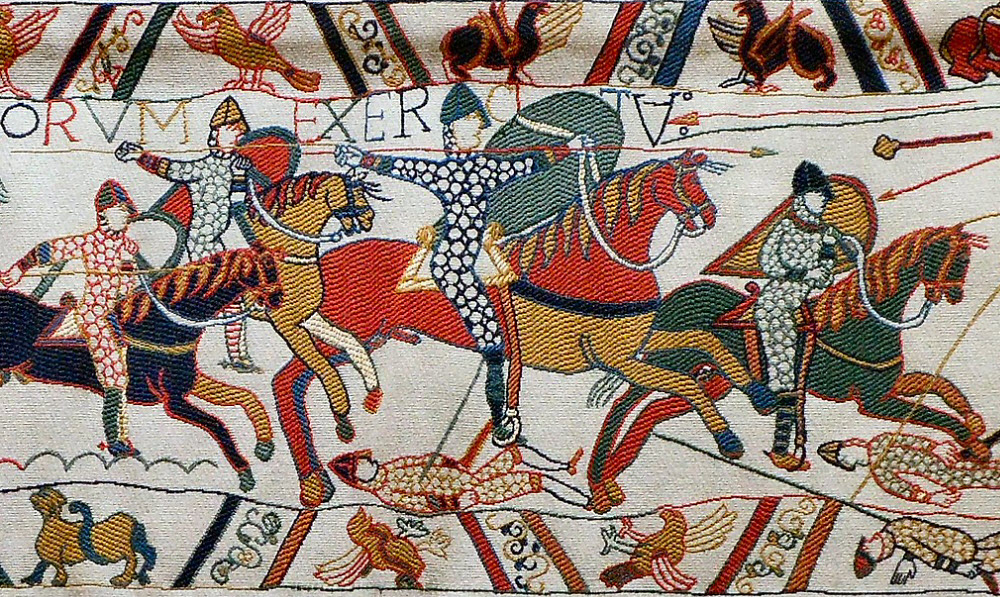 the beauty and appeal of vintage textiles - bayeux tapestry piece depicting ancient warriors on horseback