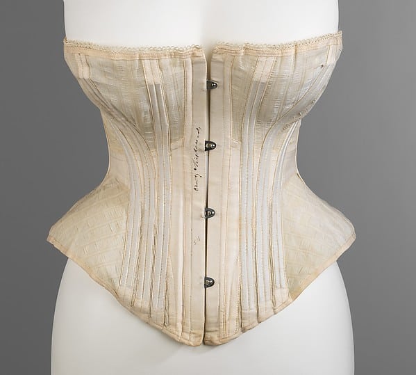 understanding the history of corsetry in fashion - busks inserted into corsets on this vintage corset on mannequin