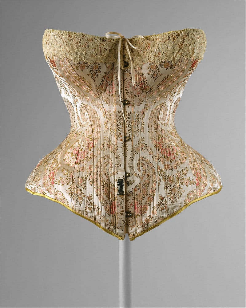 choosing the right corset for your vintage style - brocade corset on a stand with busk closure