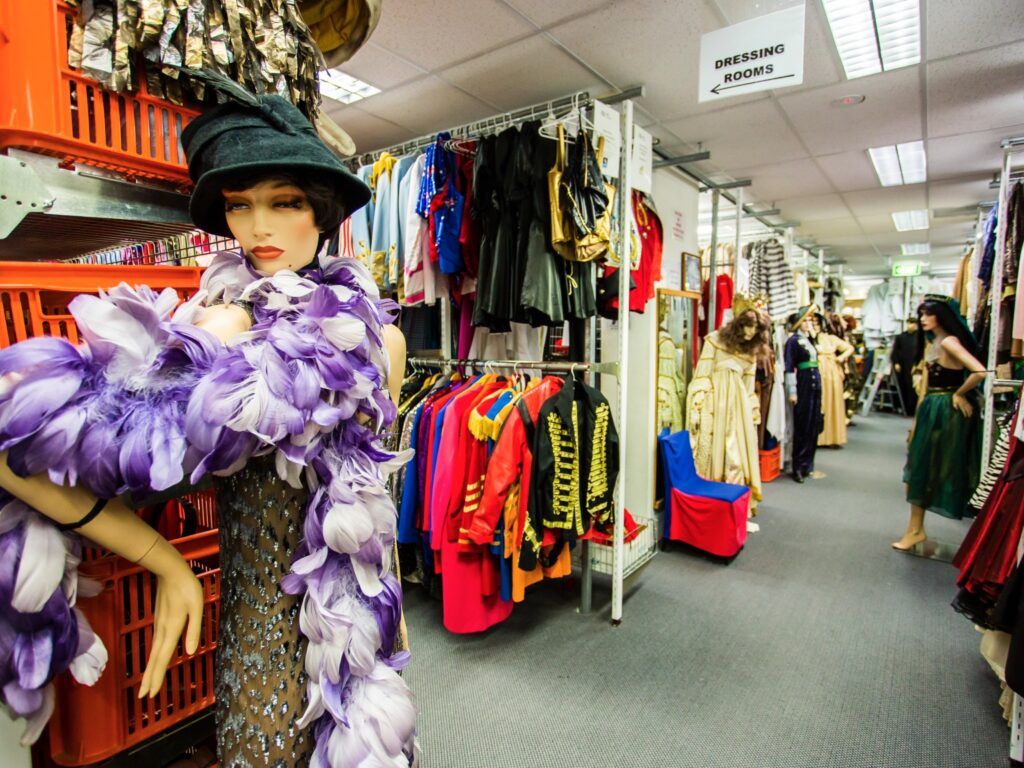 where to get it - inside view of a costume hire shop with mannequin displays