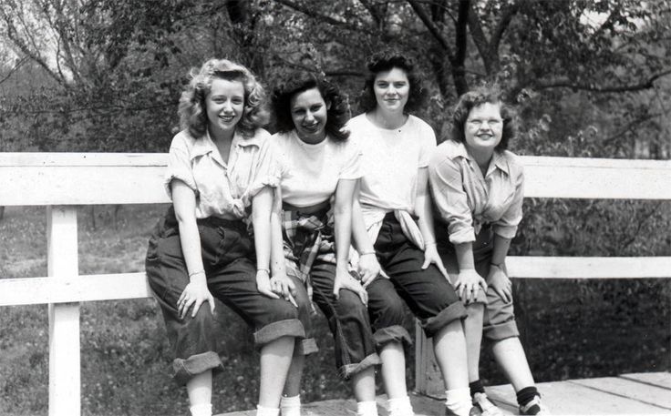 1940's/1950's era - 4 women sitting on a fence in classic white shirts and cuffed jeans