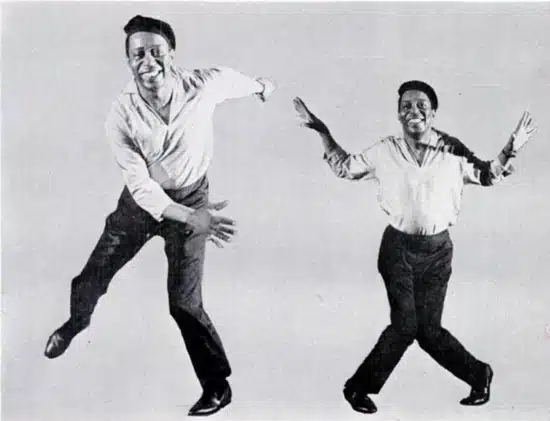 the big band era's influence on fashion - an african/american man showing the steps to the charleston swing