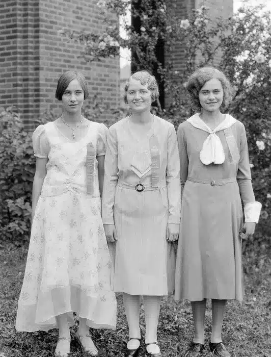 gatsby's enduring elegance - 3 normal women outside dressed for a party or special occasion in light dresses