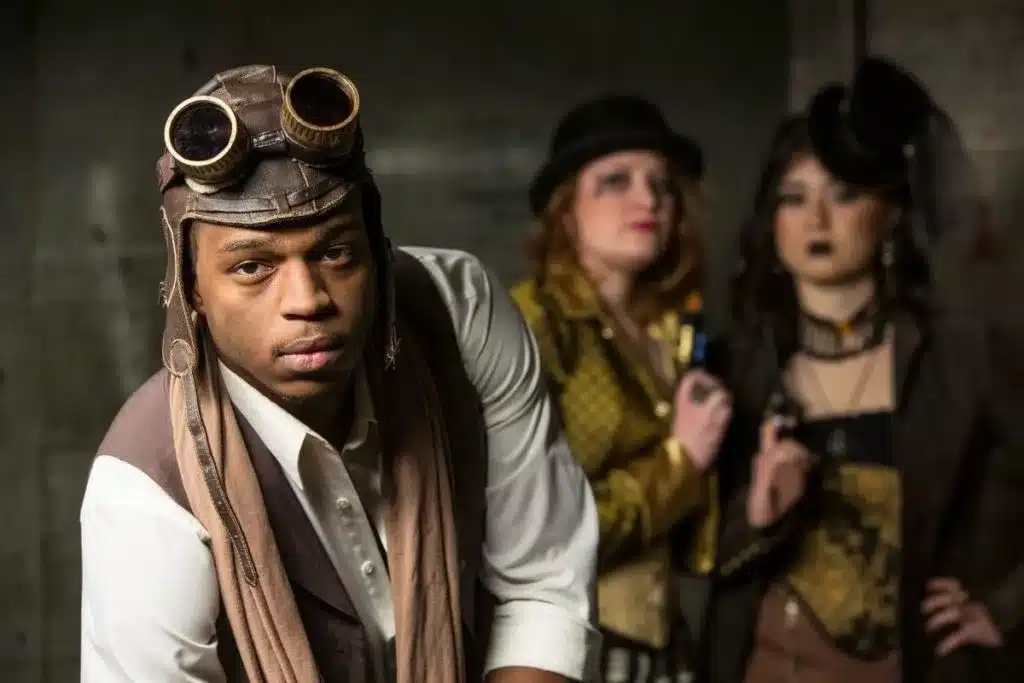 cultural significance of steampunk fashion in modern wardrobes - african/american man wearing aviator steampunk hat and scarf