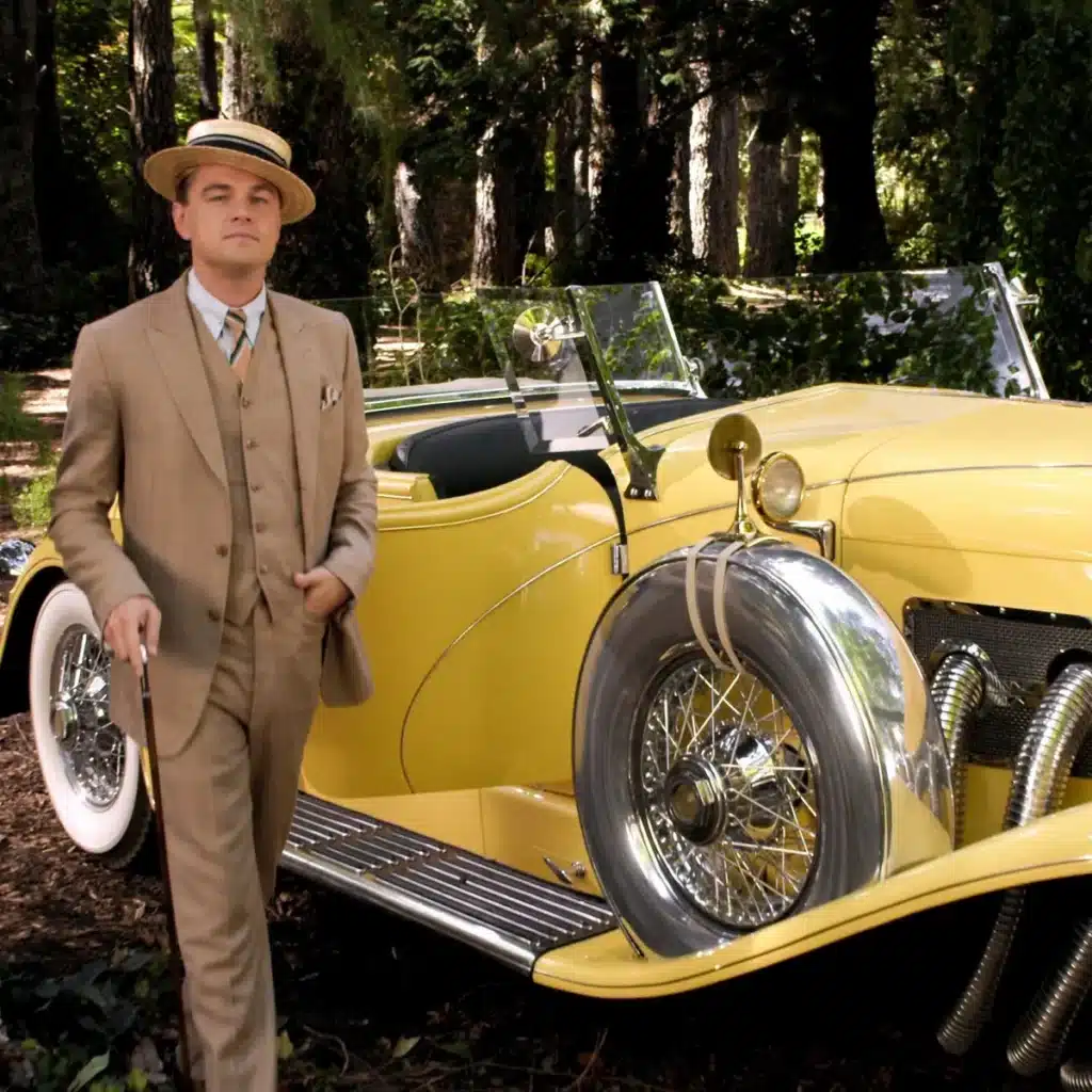 unraveling the enigma of jay gatsby - leonardo di carprio with veteran car in summer 3 piece suit and boater hat