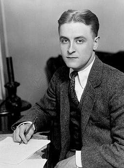 unraveling the enigma of jay gatsby - image of f scott fitzgerald sitting at a desk writing