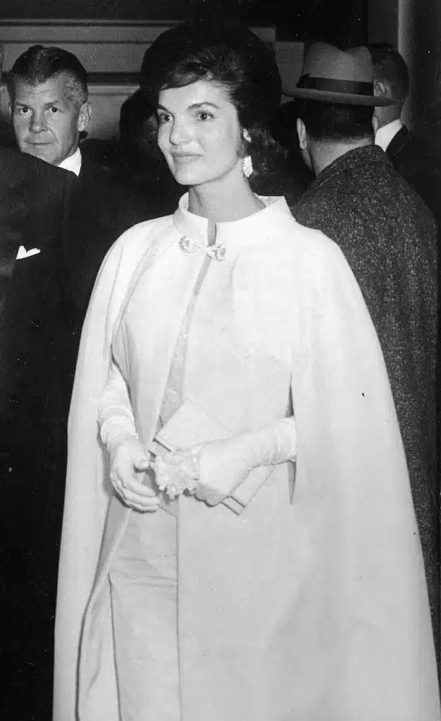 the impact of  fashion's golden age icons - jackie kennedy in a 1960's dress, gloves and matching dress coat