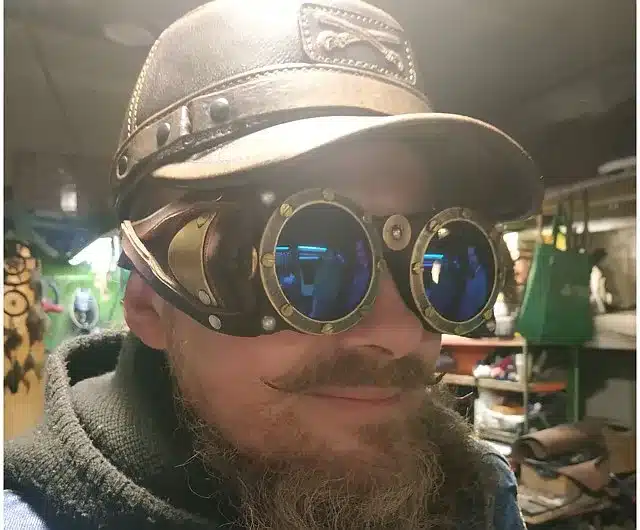 reviewing men's steampunk fashion - casual man in steampunk goggles and leather cap