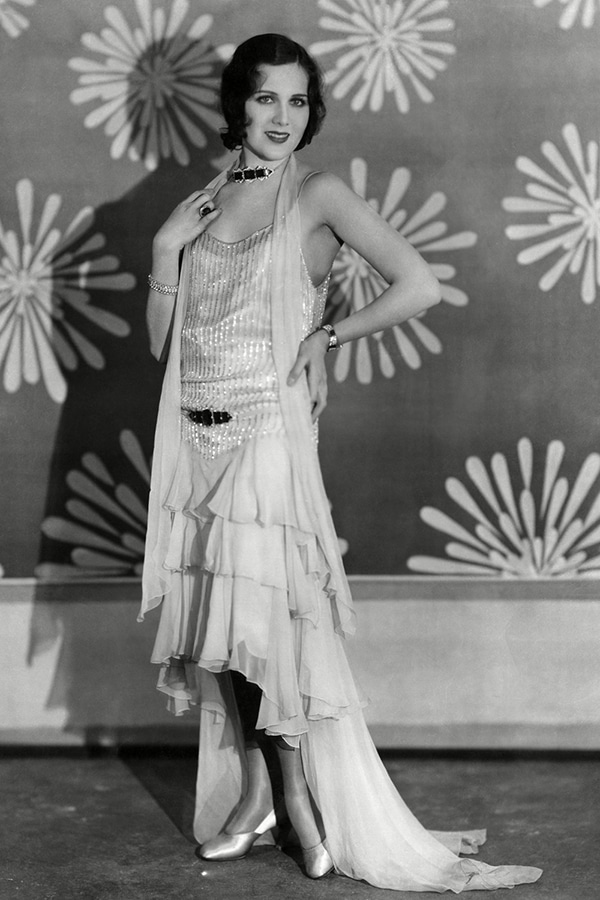 unraveling the enigma of jay gatsby - woman in 1920's hankerchief sleeveless chiffon dress