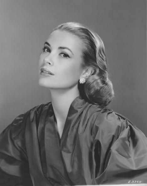 the impact of fashion's golden age icons - grace kelly in model pose wearing a taffeta dress