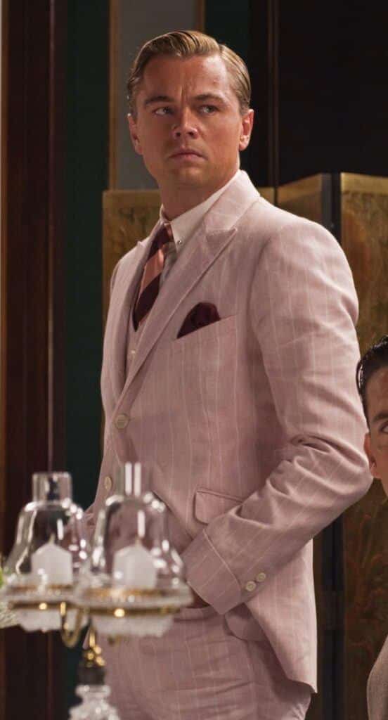 unraveling the enigma of jay gatsby - leonardo di caprio from the movie the great gatsby in a light pin striped suit