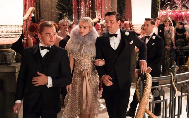 unraveling the enigma of jay gatsby - a scene from the motion picture the great gatsby - leonardo with two co-stars at a dinner party walking together