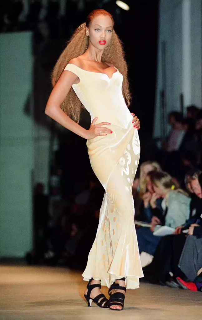 the lasting legacy of vintage icons in contemporary fashion - tyra banks modeling a 1930's inspired evening gown