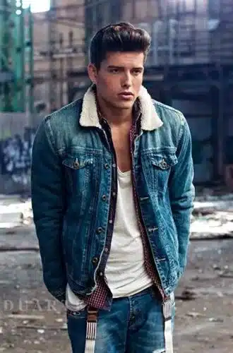 key elements of rockabilly fashion - denim and leather for men, man wearing denim jacket trimmed with lambskin sporting quiff hairstyle