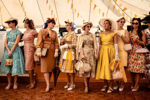 assessing the value and rarity of authentic vintage clothing materials - group of women in 1950' dresses and outfits at a parade 