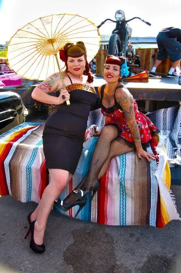 tips for pulling off a rockabilly look with modern flair at the shops - 2 woman dressed in different rockabilly dresses but both sporting tattoos and bangs
