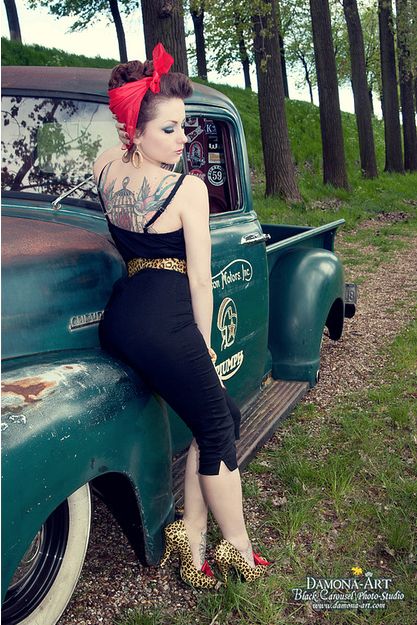 key elements of rockabilly fashion, traditional tattoos - woman sporting tattoos on her back wearing tight jumpsuit and headscarf