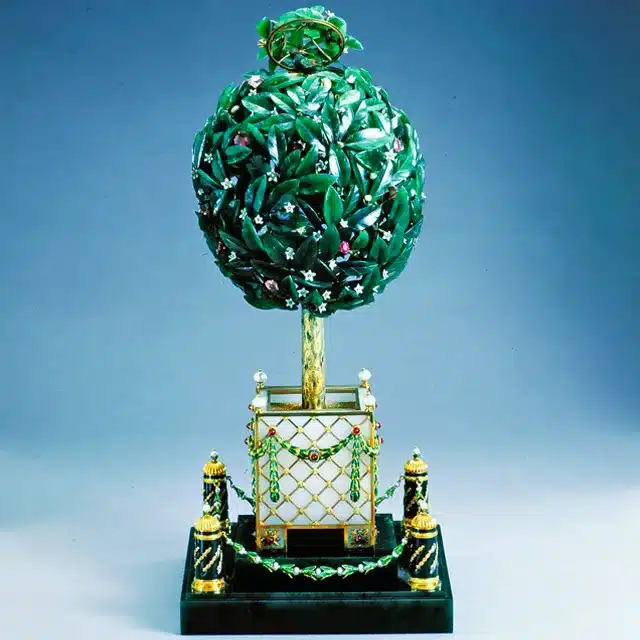 how the faberge egg symbolized the fusion of artistry, innovation and tradition - bay tree egg circa 1911 in a pot surrounded by a podium made of emeralds gold and other stones