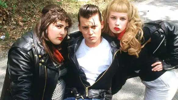reviewing the essence of rockabilly style for men - 3 groupies wearing leather jackets, pompadour hair and bangs 
