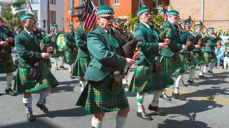 embracing green - the roots of celtic clothing - bagpipe band marching in traditional dress uniform