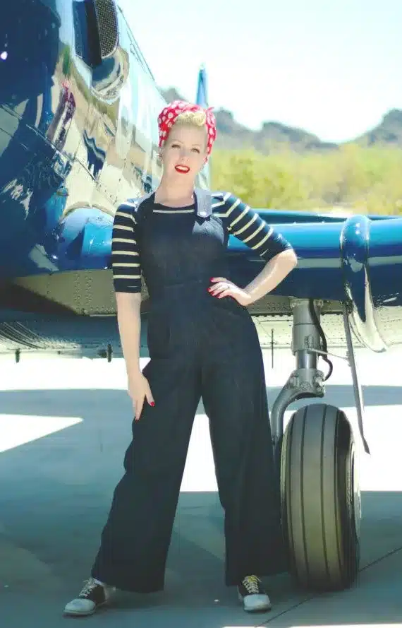 vintage work-wear essentials - from practicality to empowerment, woman in denim overalls and 1950's headscarf near vintage aeroplane