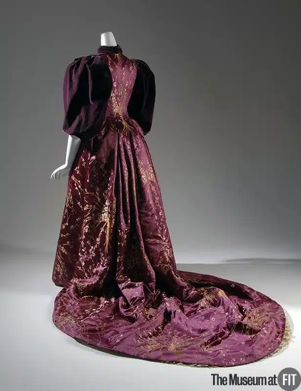 the historic allure of velvet in fashion - plum coloured 1894 evening gown on mannequin