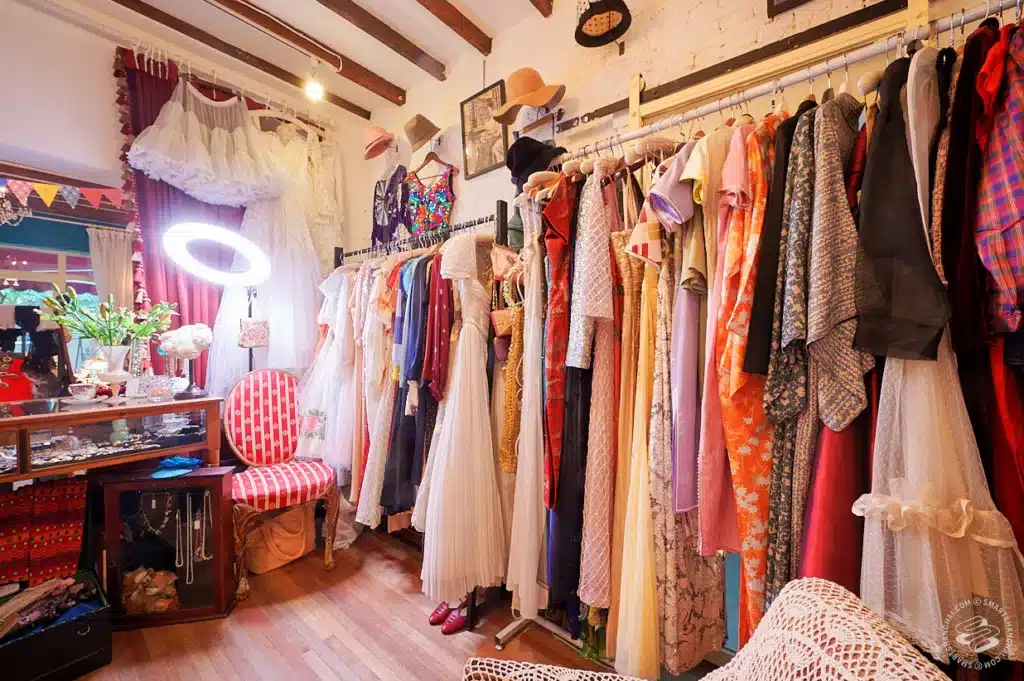 curating key vintage pieces - where to begin, inside a vintage or thrift shop with dresses displayed