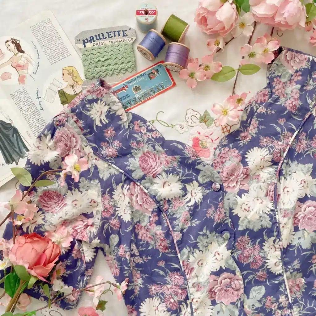 care and maintenance of vintage garments-floral dress next to pattern, threads and trims