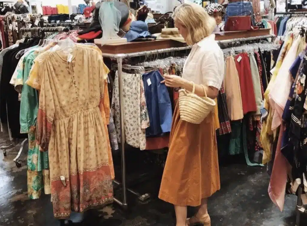 key vintage pieces - where to begin,  woman looking through skirts in a vintage or thrift shop