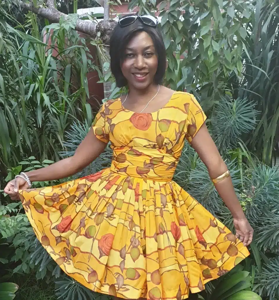 sustainable fashion-role of vintage clothing-african/american woman wearing bright yellow swing dress