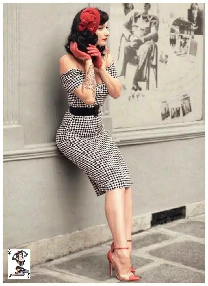 Guide to building a vintage wardrobe - woman leaning back with black and  white fitted houndstooth dress belted and off the shoulder