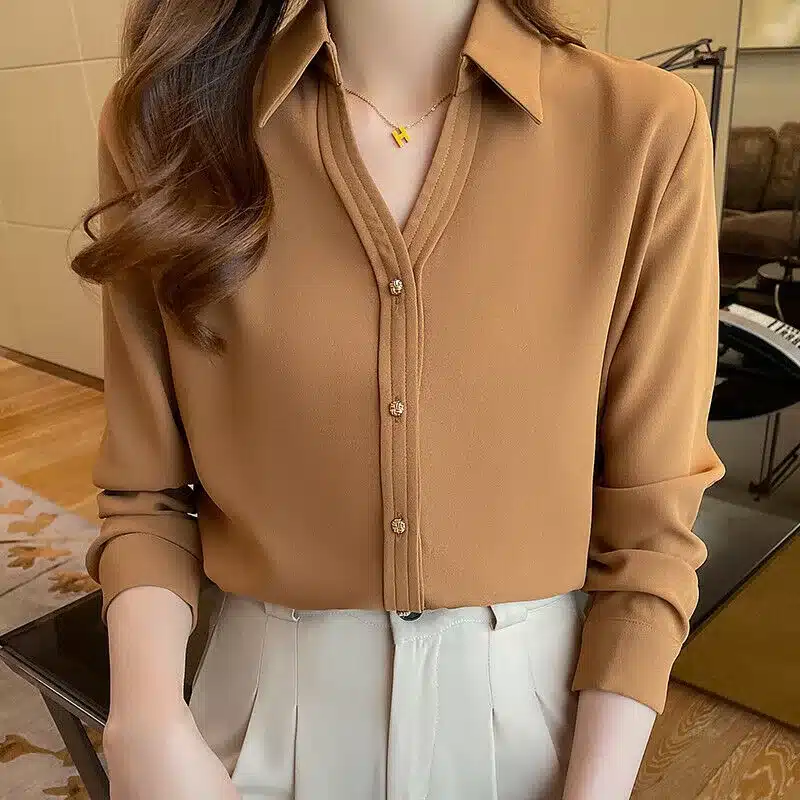 vintage work-wear essentials - from practicality to empowerment - woman's button up blouse in fawn colour