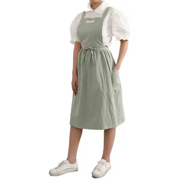 vintage work-wear essentials - from practicality to empowerment, woman in pastel apron over white blouse and sneakers