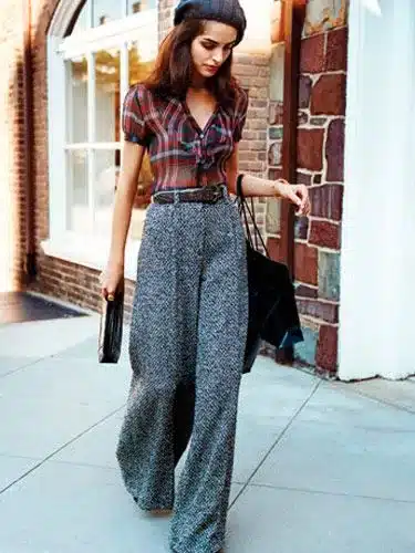 From Flapper dresses to bell bottom pants - key vintage trends making a comeback - woman wearing wide leg belted pants with a 1930's inspired blouse