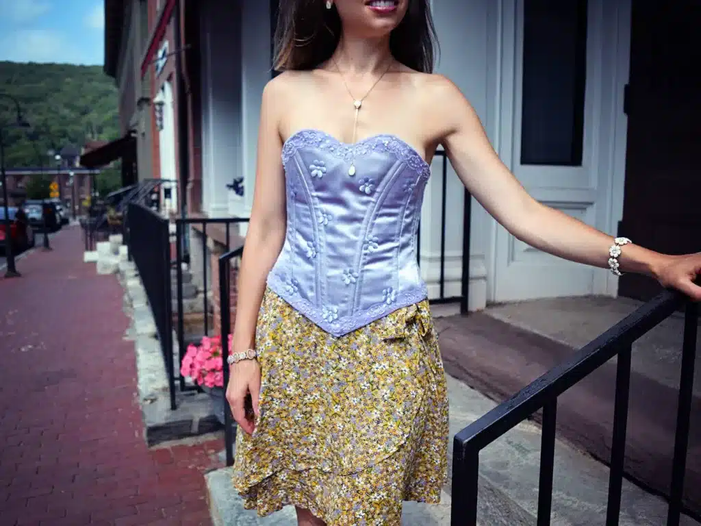 how to incorporate corsets into modern wardrobes - girl dressed in lilac corset matching a floral skirt