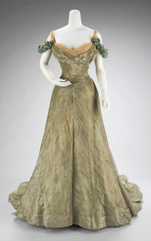 Edwardian evening dress in dusty green with dropped shoulder sleeves, ruched bust and contrast lining around neckline with ruffle hem