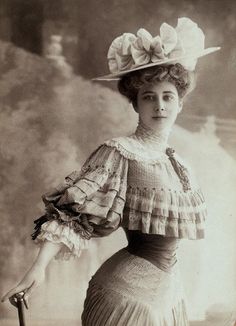 Classic Edwardian lady with the S-bend silhouette figure in a ruffled top, hat and fitted skirt